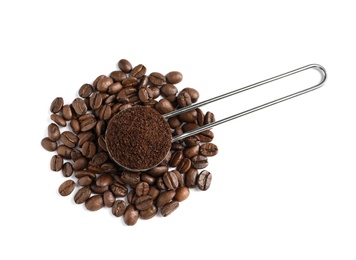 Photo of Scoop with coffee grounds and roasted beans on white background, top view