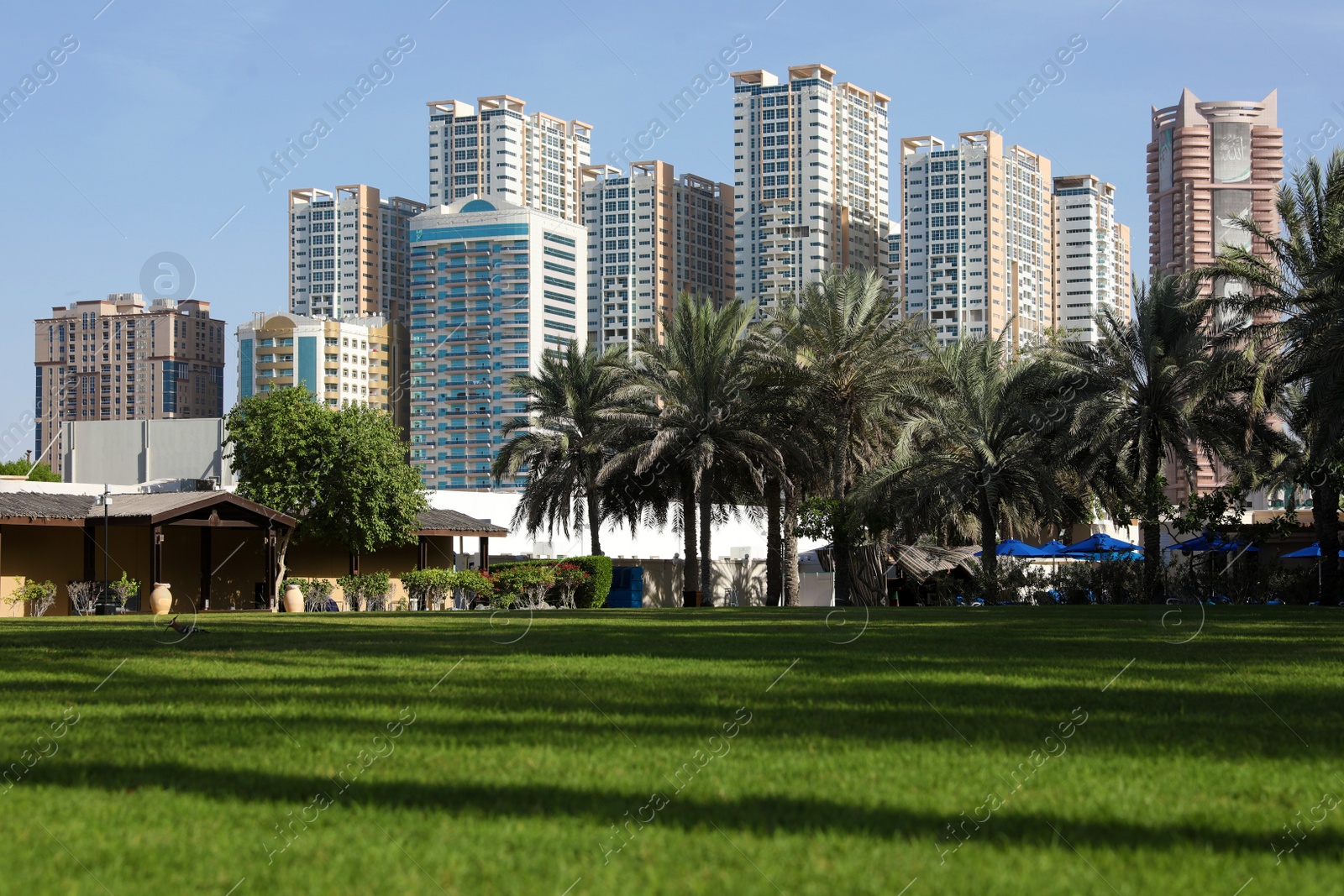 Photo of SHARJAH, UNITED ARAB EMIRATES - NOVEMBER 04, 2018: Beautiful landscape with green park near tropical resort