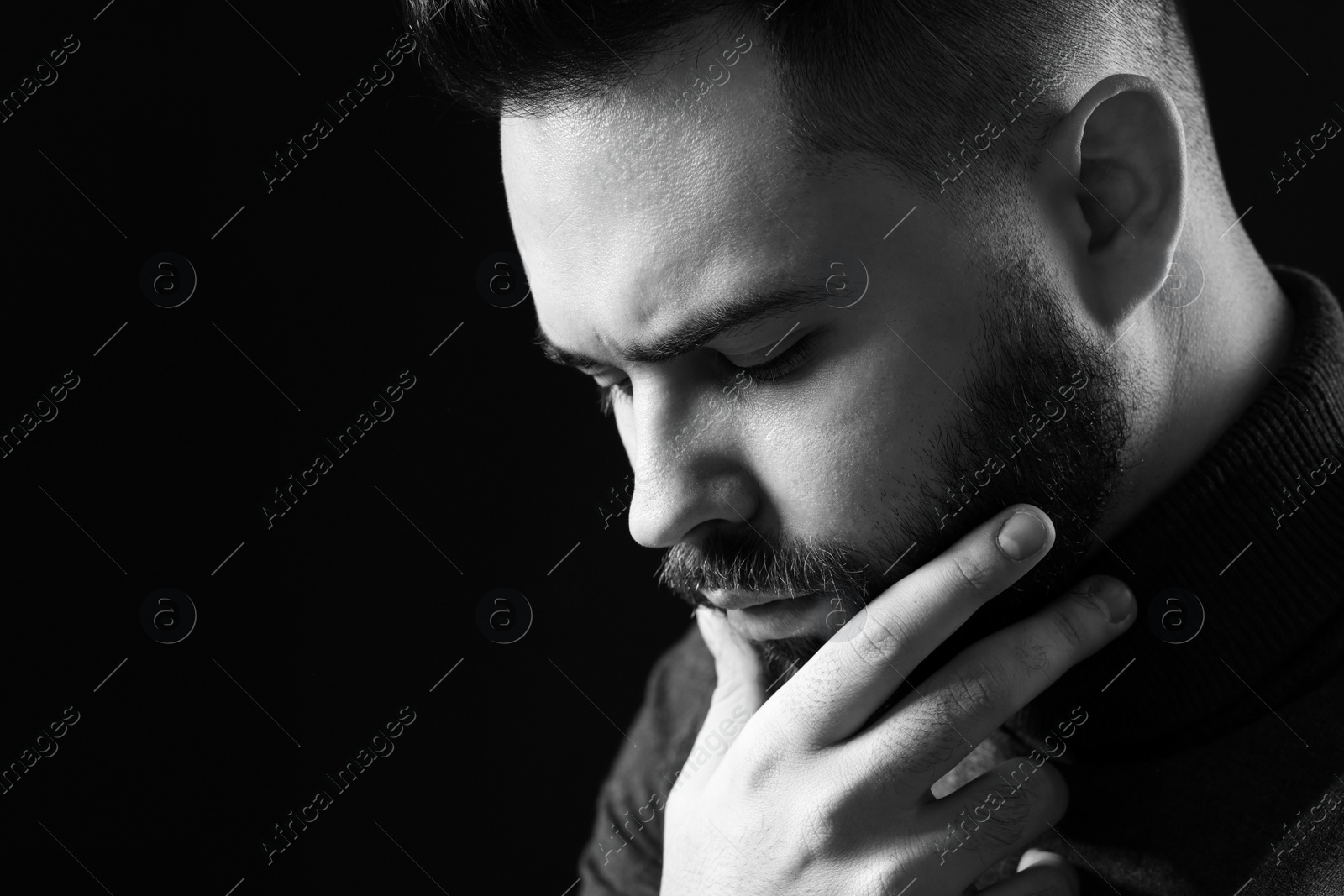 Photo of Portrait of handsome bearded man on dark background, space for text. Black and white effect