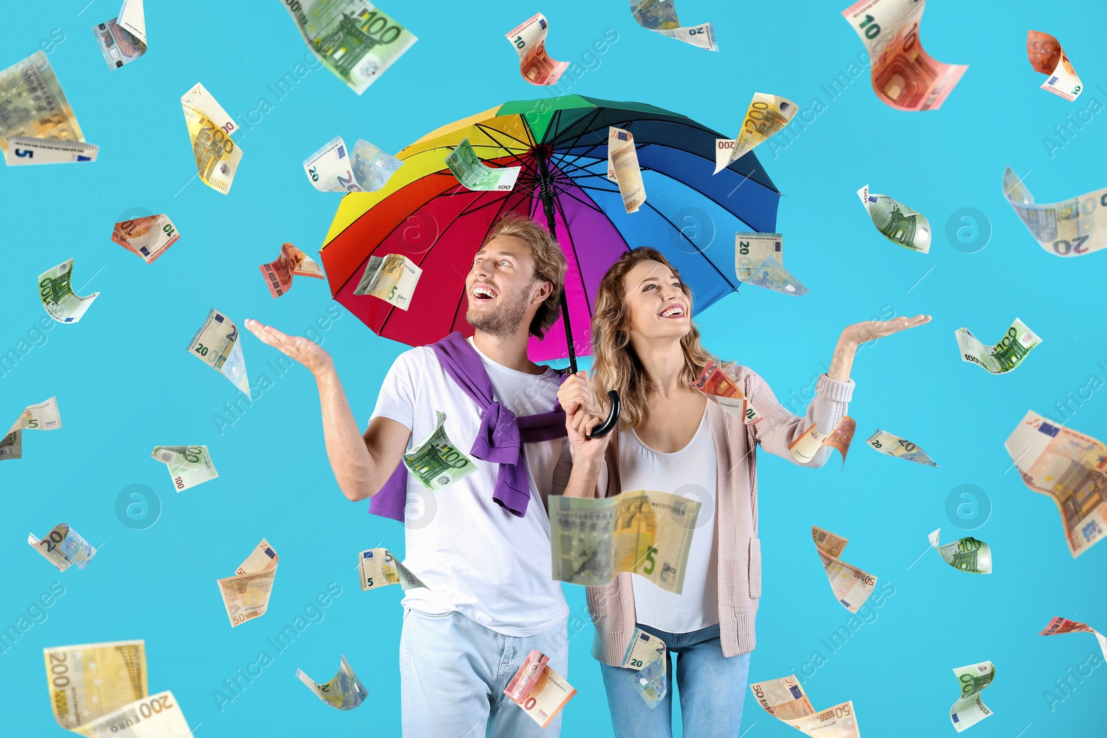 Image of Couple with umbrella under money rain on color background 