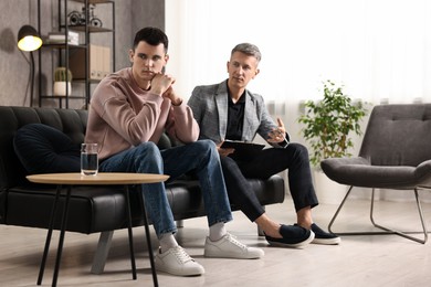 Photo of Professional psychotherapist working with patient in office