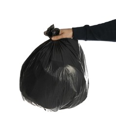 Man holding trash bag filled with garbage on white background, closeup