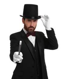 Magician in top hat holding wand on white background