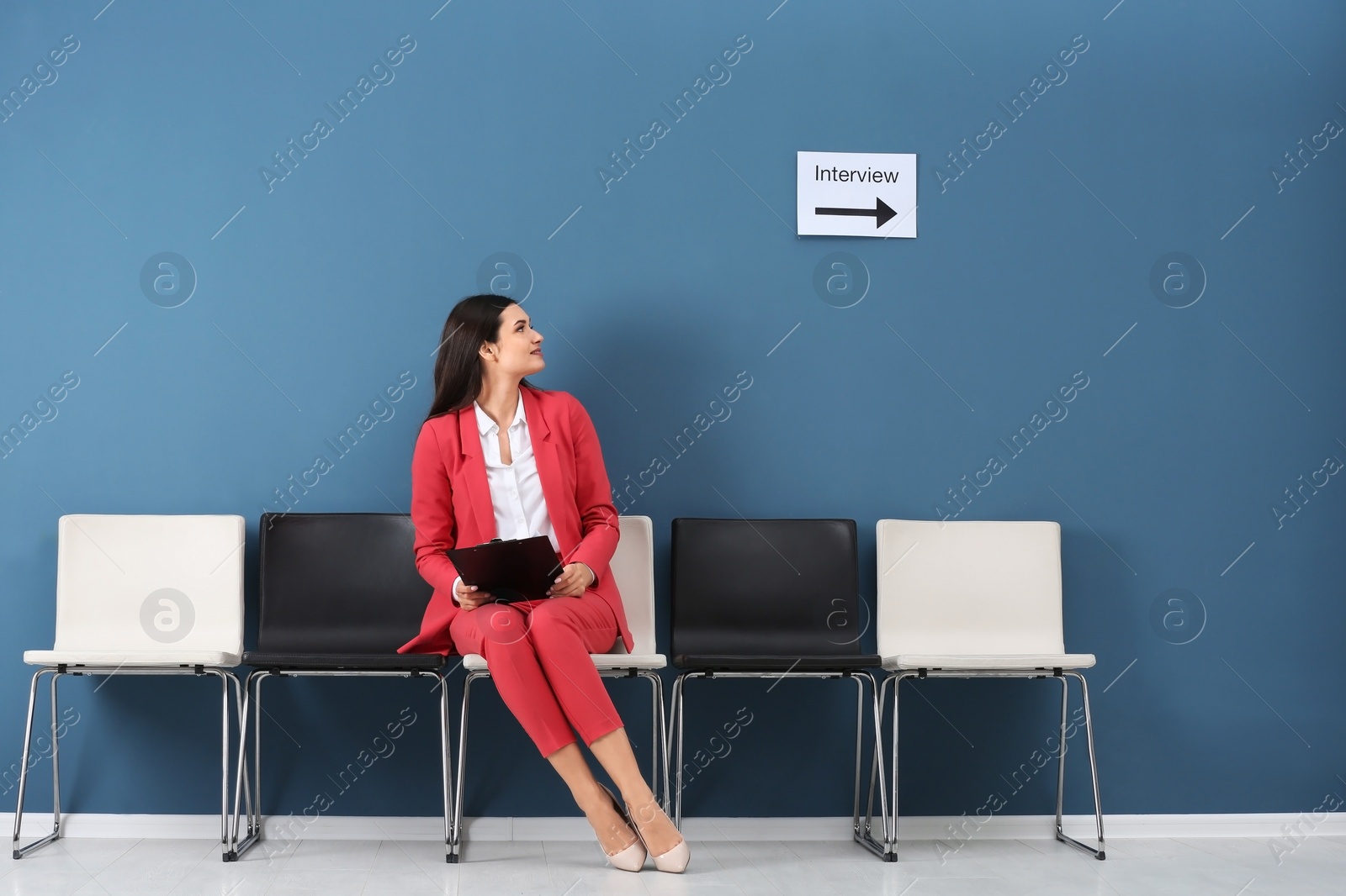 Photo of Young woman waiting for job interview, indoors