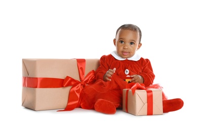 Photo of Little African-American baby with Christmas gifts on white background