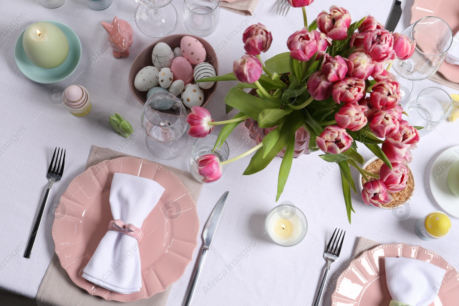 Photo of Festive table setting with beautiful flowers, flat lay. Easter celebration