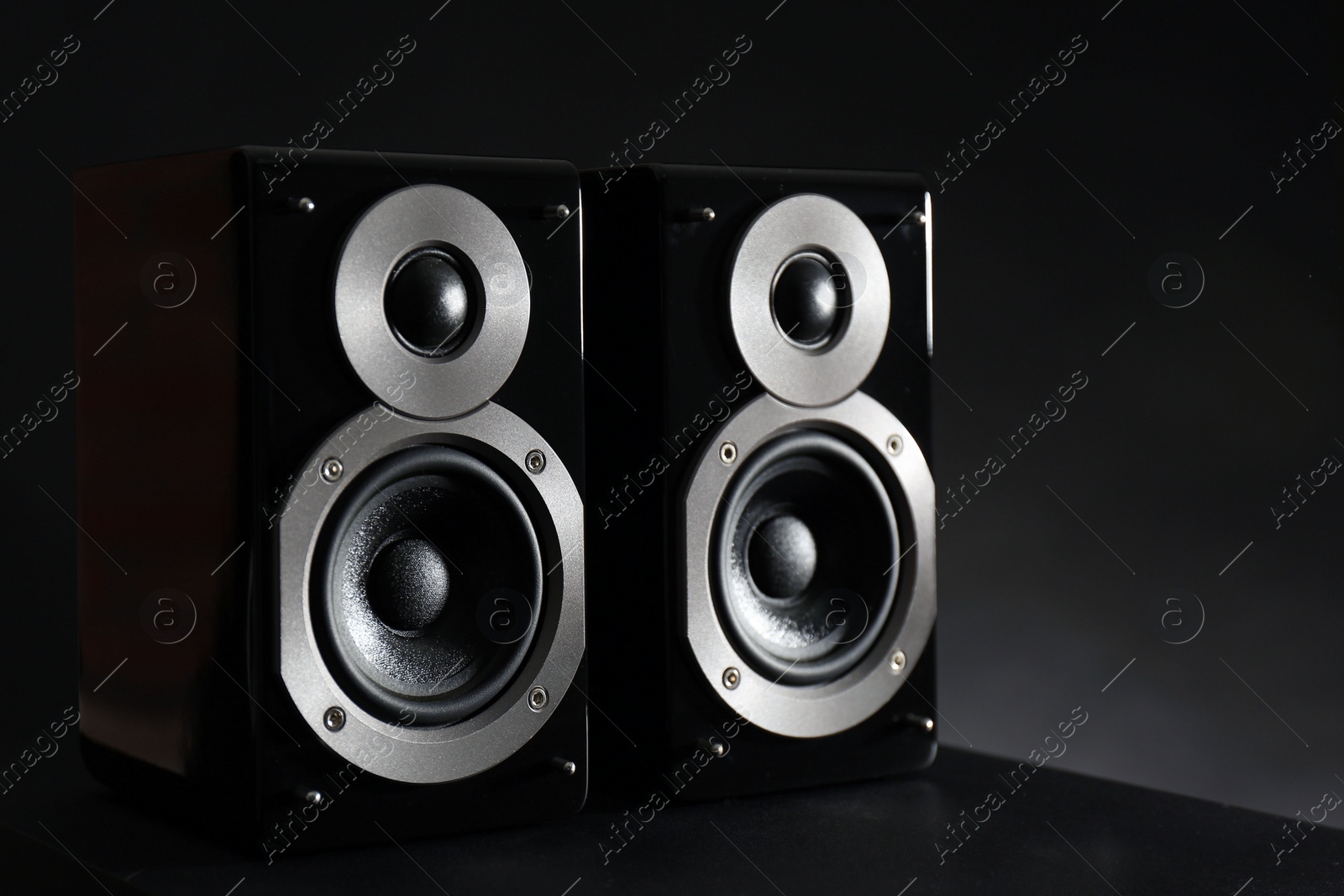Photo of Modern powerful audio speakers on black table