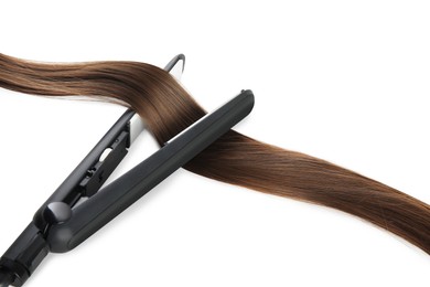 Photo of Modern straightener with brown hair lock on white background