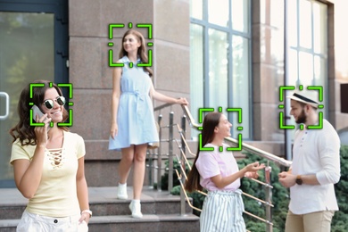 Facial recognition system identifying people on city street 
