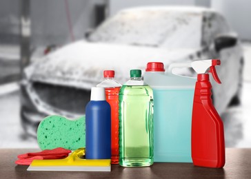 Cleaning supplies on wooden surface at car wash