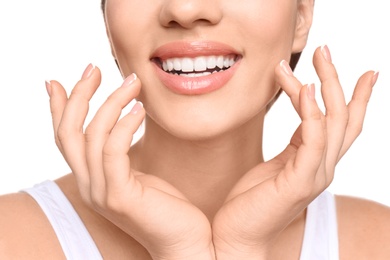 Young woman with beautiful smile on white background, closeup. Teeth whitening