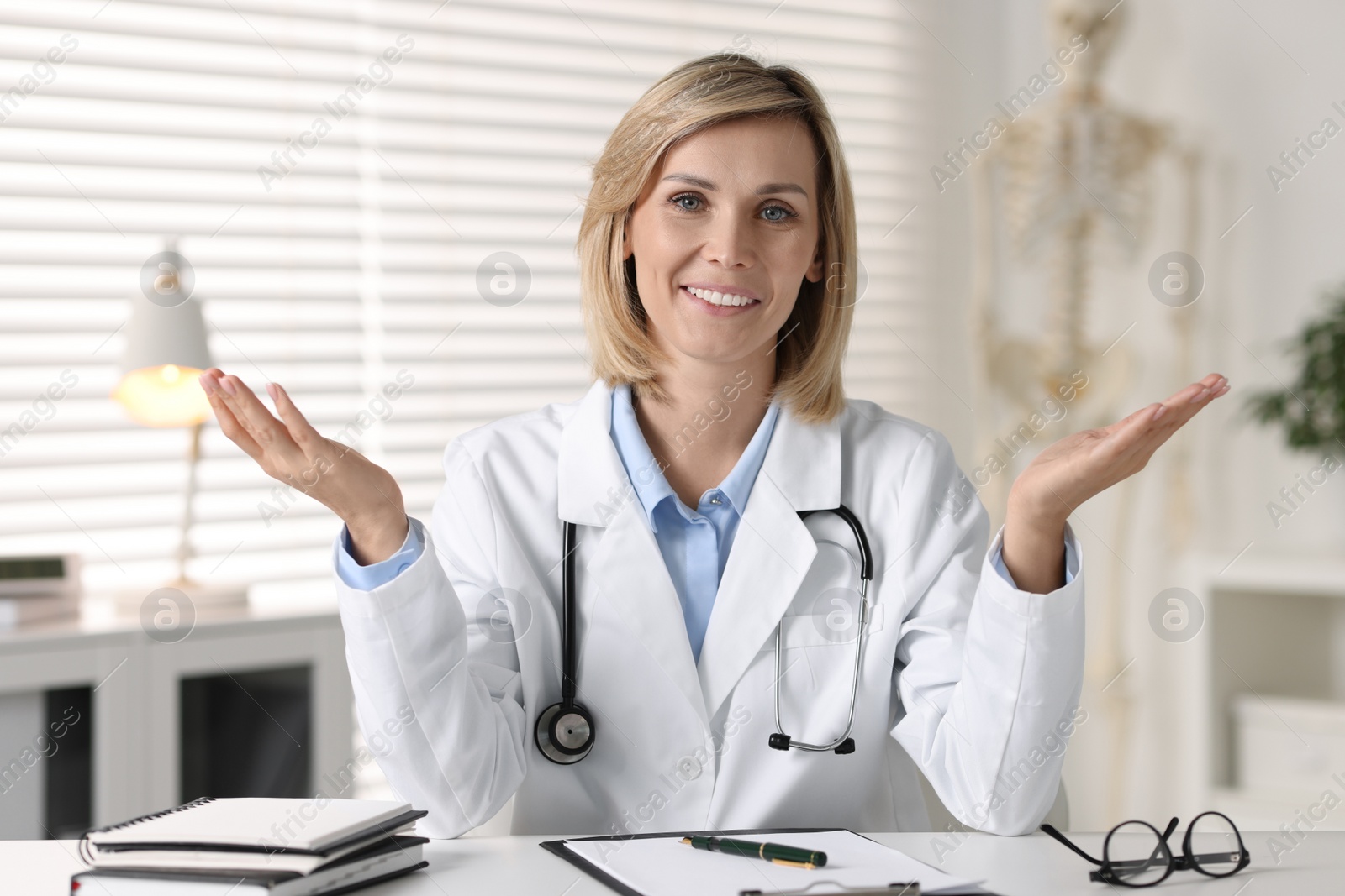 Photo of Portrait of smiling doctor at table in office