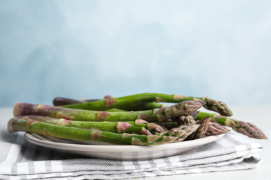 Photo of Fresh raw asparagus on table, closeup view