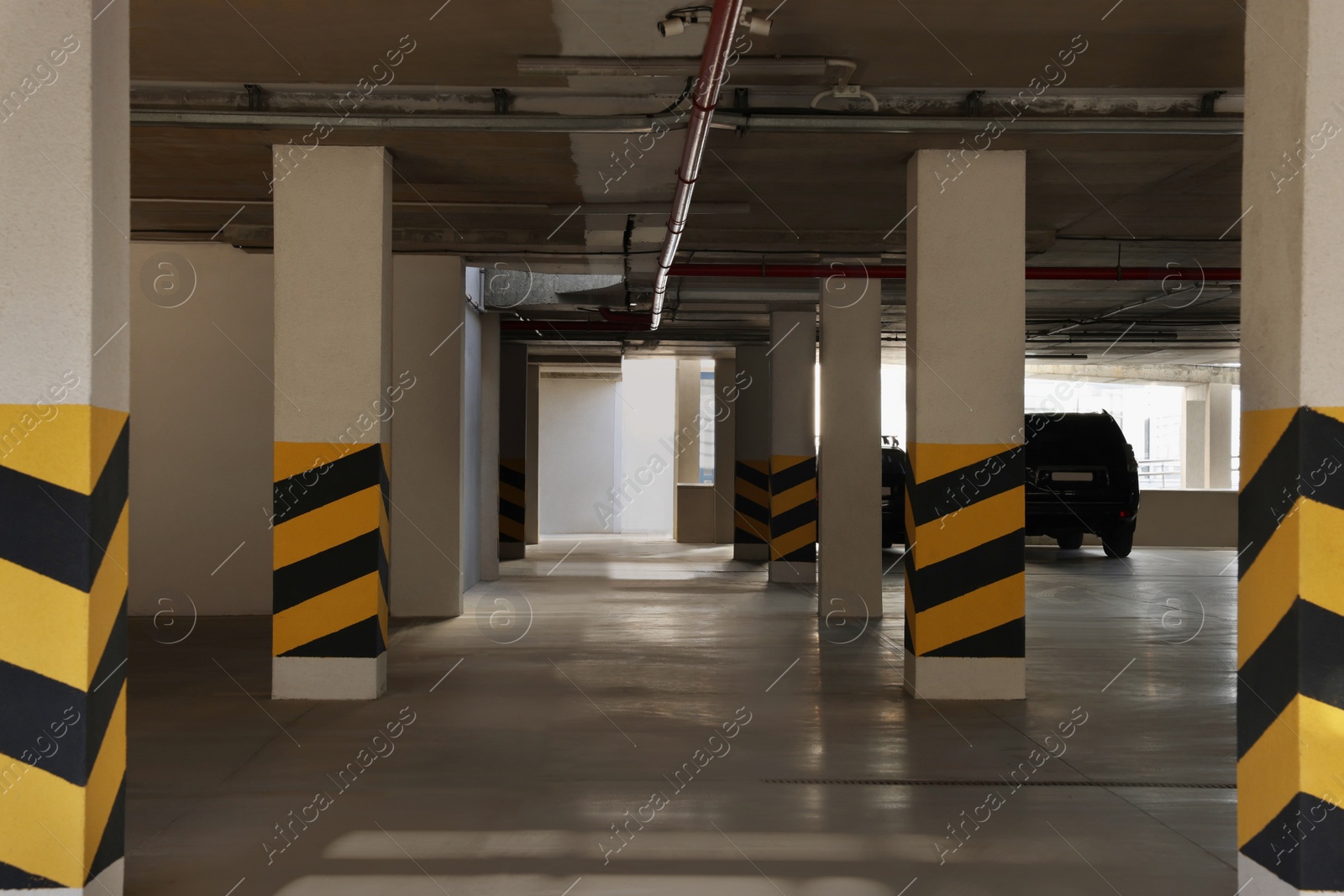 Photo of Open parking garage with cars on sunny day