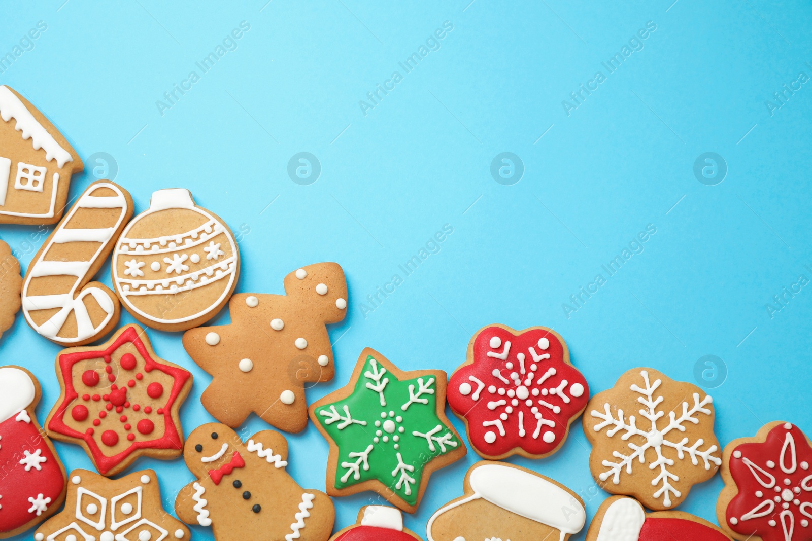 Photo of Flat lay composition with tasty homemade Christmas cookies on light blue background, space for text