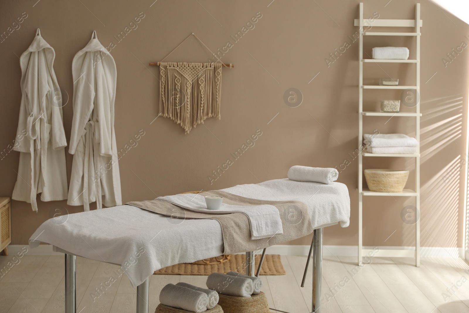 Photo of Stylish spa salon interior with massage table