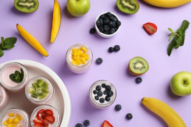 Photo of Yogurt maker with jars and different fruits on lilac background, flat lay