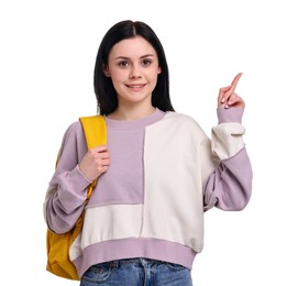 Happy student with backpack pointing at something on white background