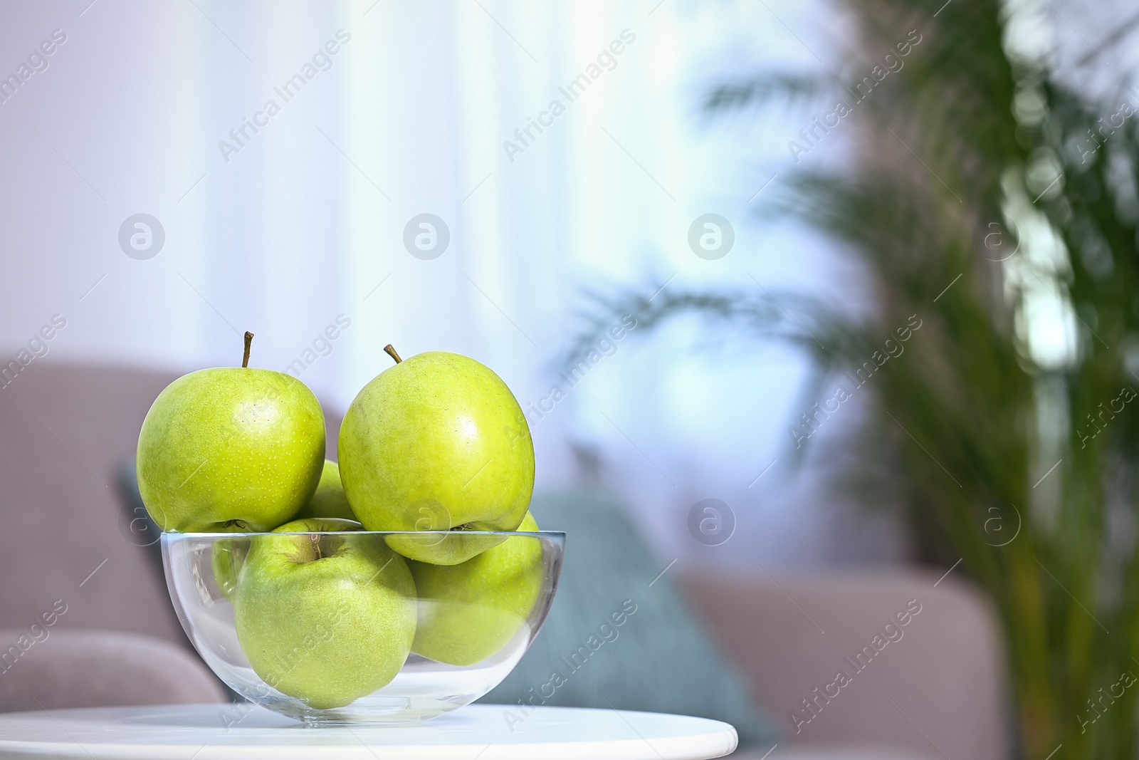 Photo of Bowl of fresh green apples on table indoors. Space for text