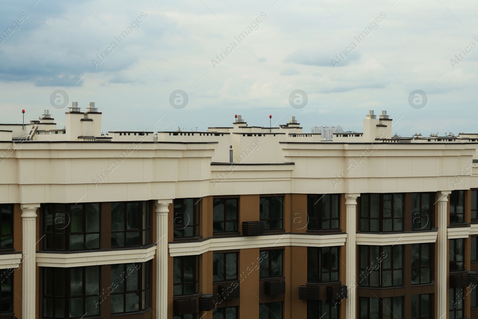 Photo of Beautiful residential building with many windows under cloudy sky