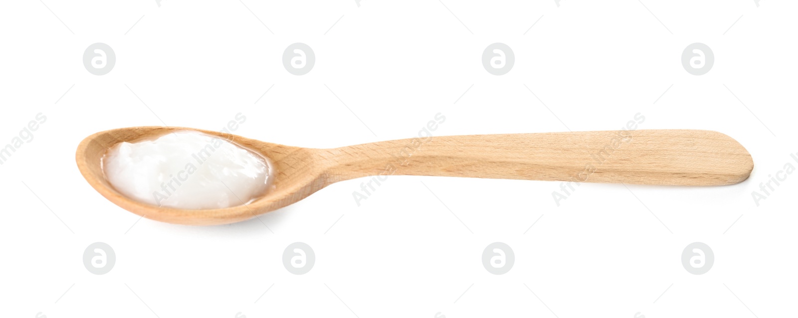 Photo of Organic coconut oil in wooden spoon isolated on white. Healthy cooking