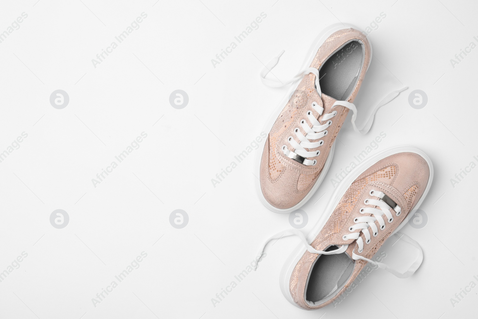 Photo of Stylish sneakers on white background, top view