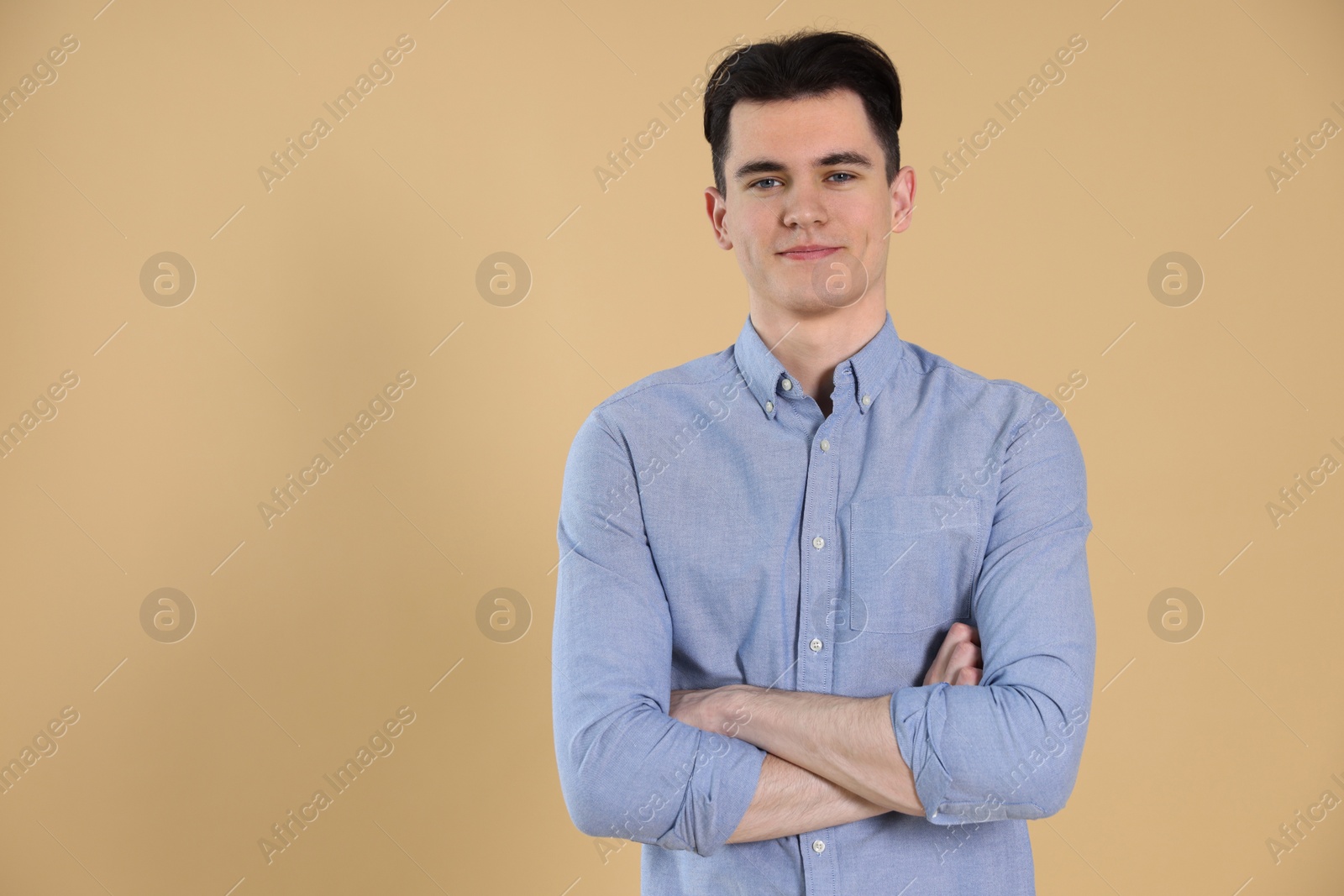 Photo of Portrait of handsome young man on beige background, space for text
