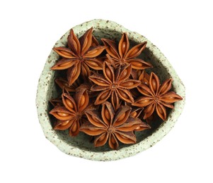 Photo of Bowl with dry anise stars on white background, top view