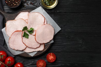 Photo of Delicious cut ham with parsley on black wooden table, flat lay. Space for text