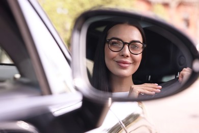 Photo of Woman with safety seat belt driving her modern car