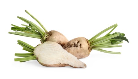 Photo of Whole and cut sugar beets on white background