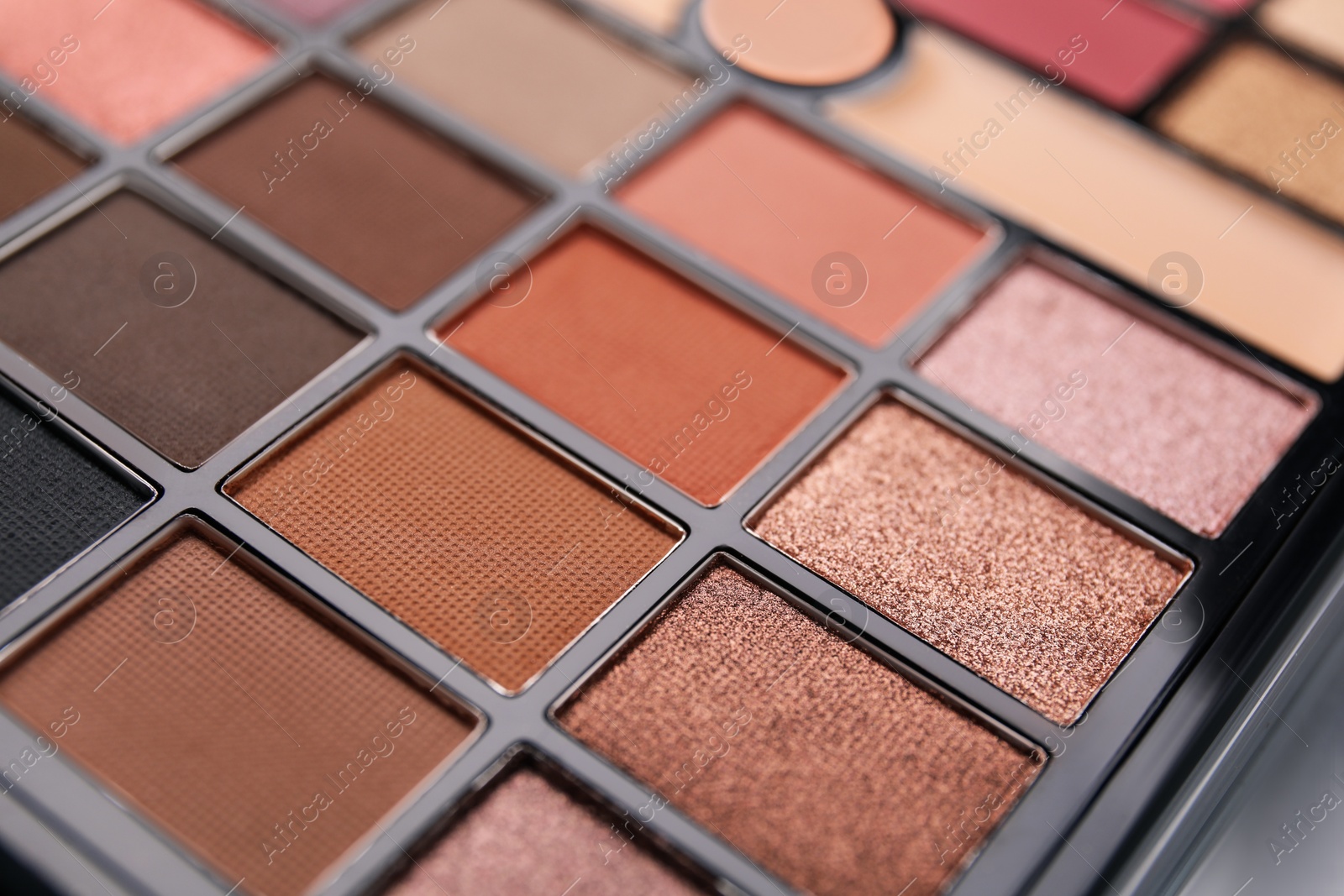 Photo of Beautiful eyeshadow palette as background, closeup. Professional cosmetic product