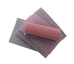 Photo of Many sheets of sandpaper isolated on white, top view