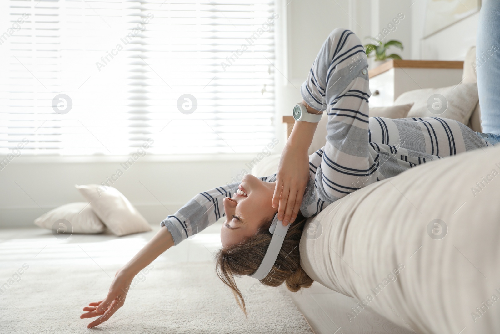 Photo of Young woman listening to music at home