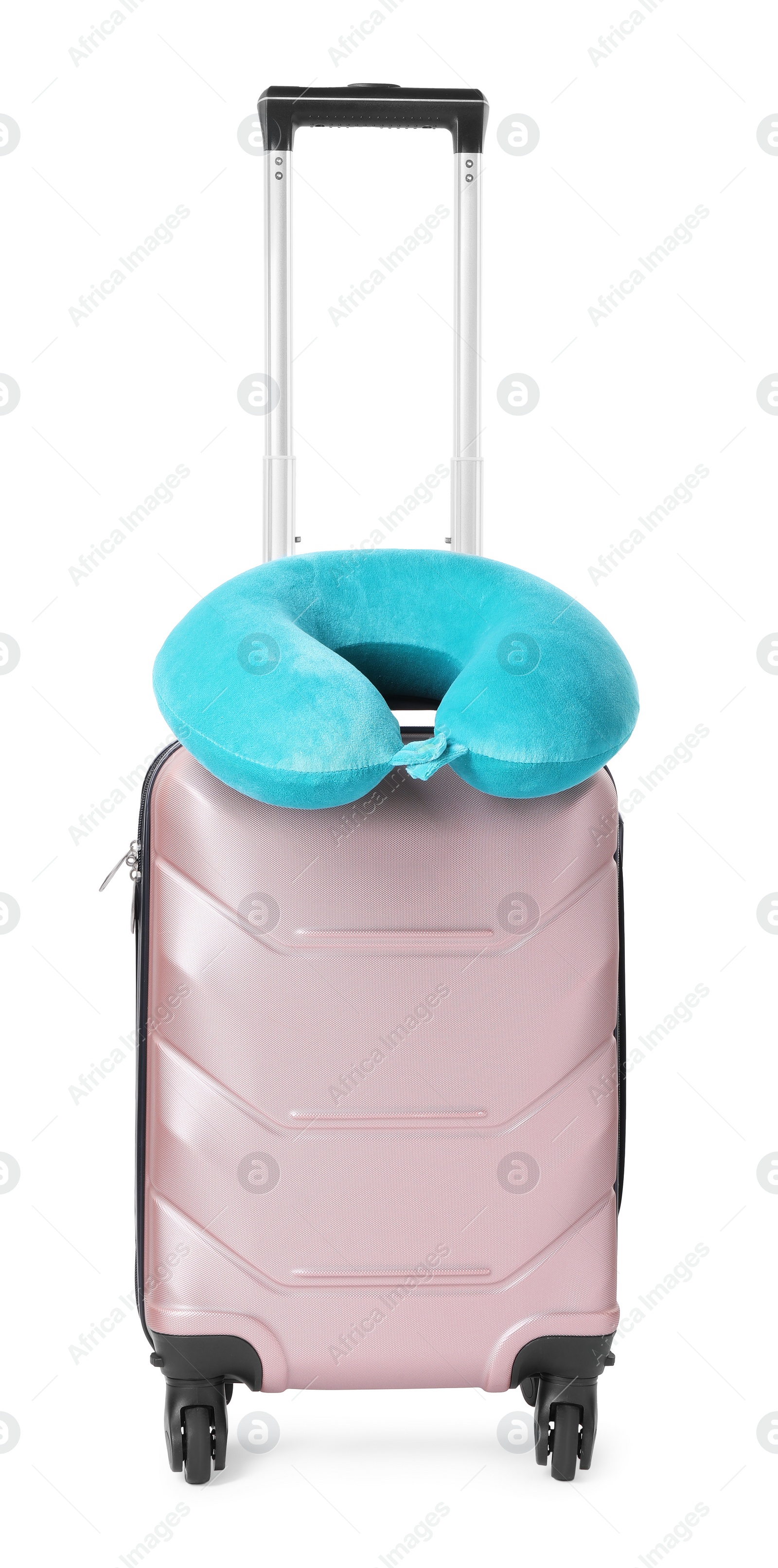 Photo of Light blue travel pillow on suitcase against white background