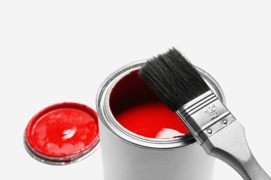 Photo of Paint can with brush on white background, closeup