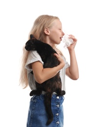 Little girl with cat suffering from allergy on white background