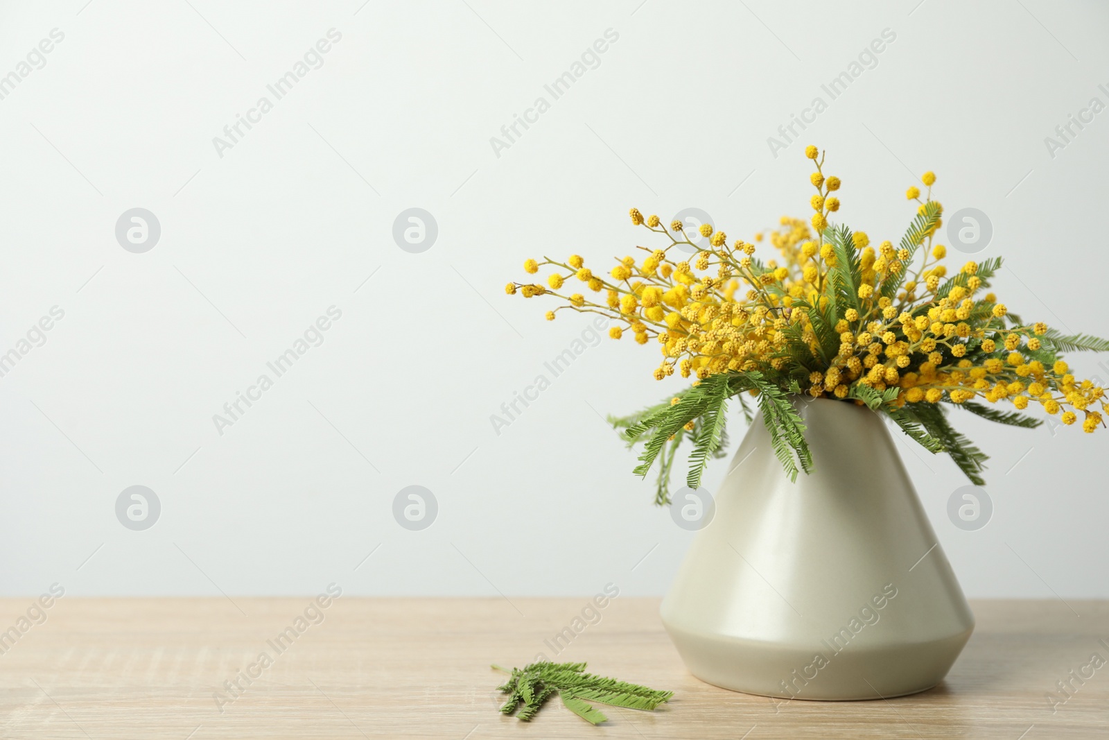 Photo of Bouquet of beautiful mimosa flowers on wooden table