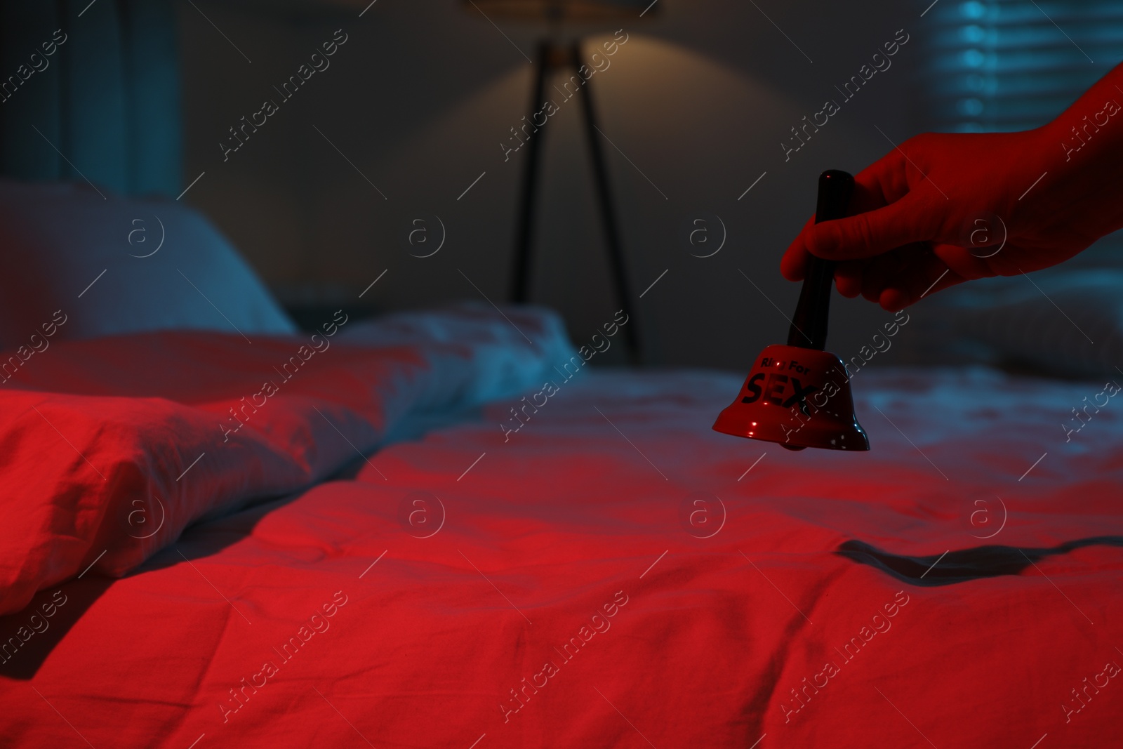 Photo of Woman with ring for sex bell in bedroom at night, closeup