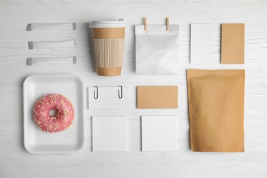 Photo of Flat lay composition with items for mock up design on wooden background. Food delivery service