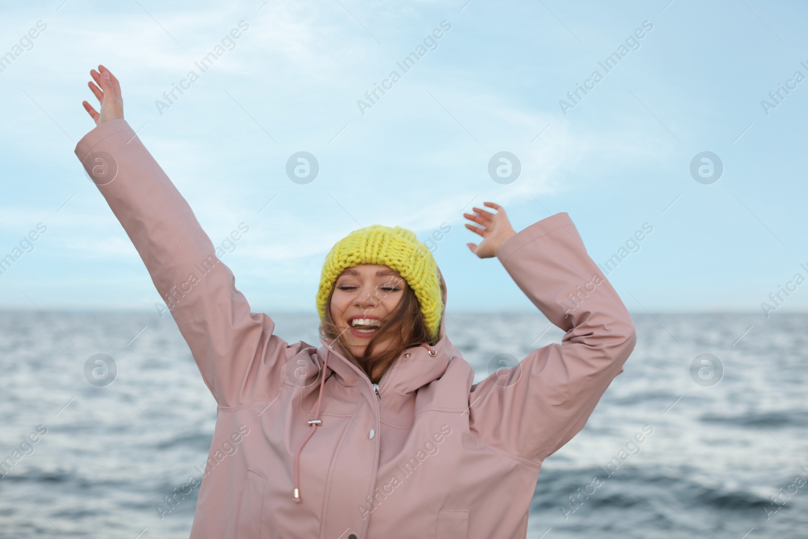 Photo of Stylish young woman spending time near sea