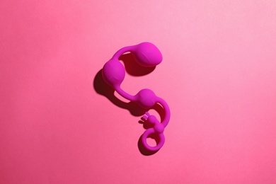 Photo of Anal balls on pink background, top view. Sex toy