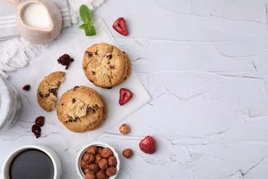 Photo of Cookies with freeze dried fruits, mint, milk, coffee and nuts on white textured table, flat lay. Space for text