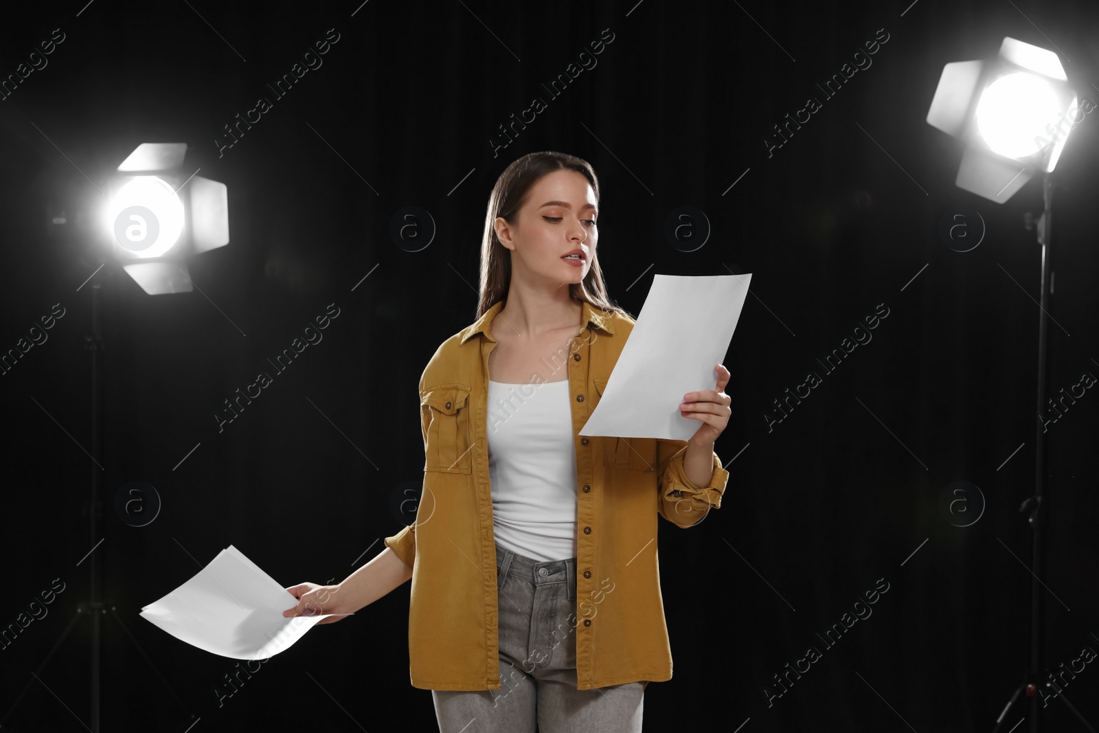 Photo of Professional actress reading her script during rehearsal in theatre