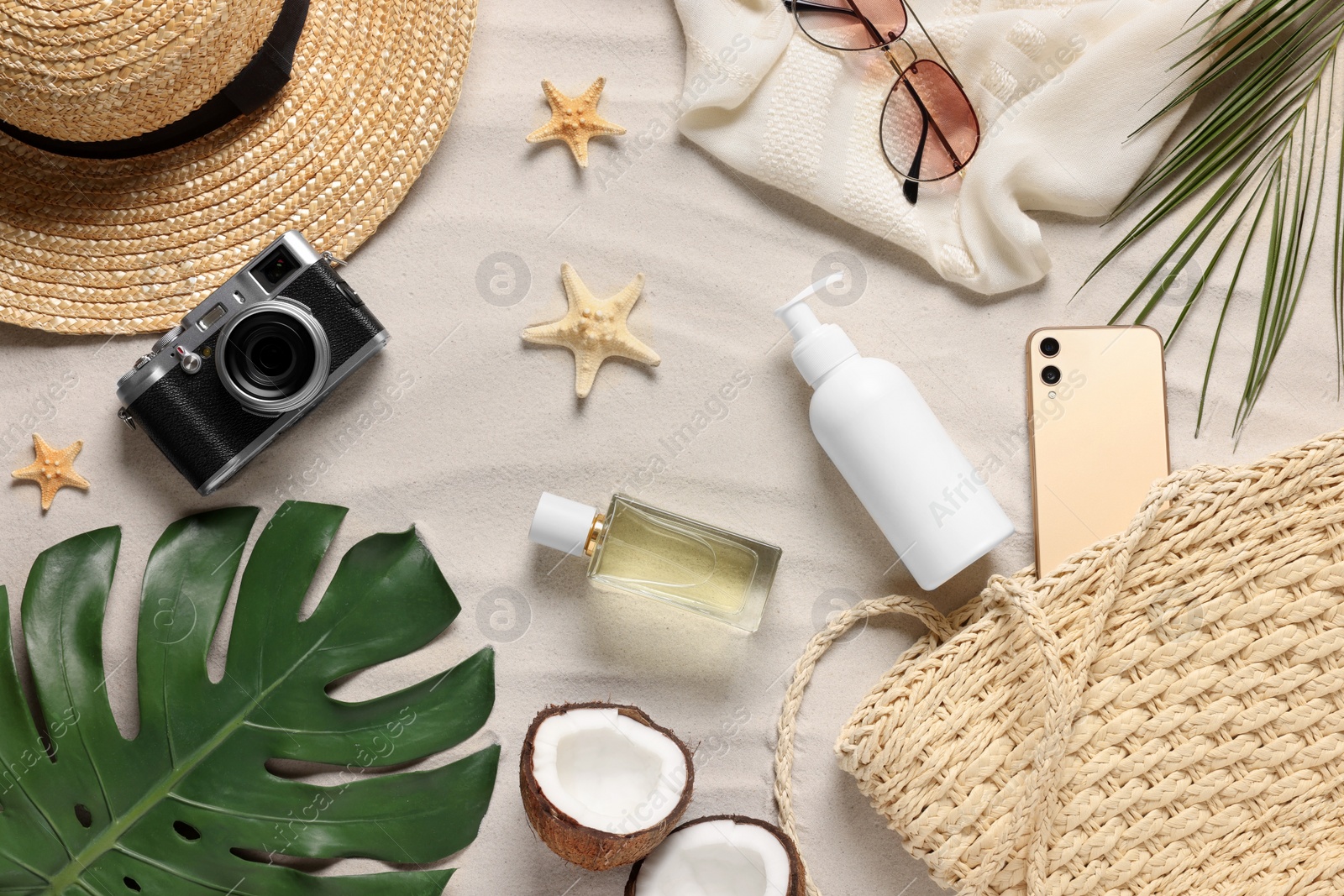 Photo of Flat lay composition with beach accessories on sand