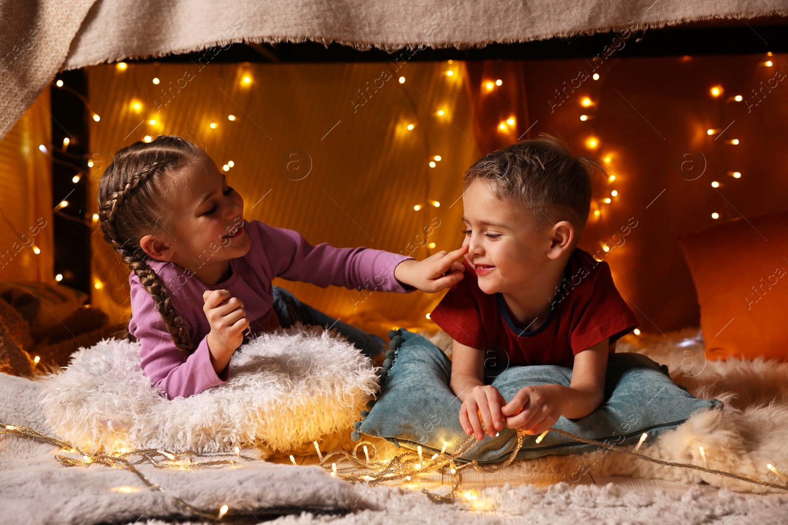 Photo of Happy kids playing in decorated play tent at home