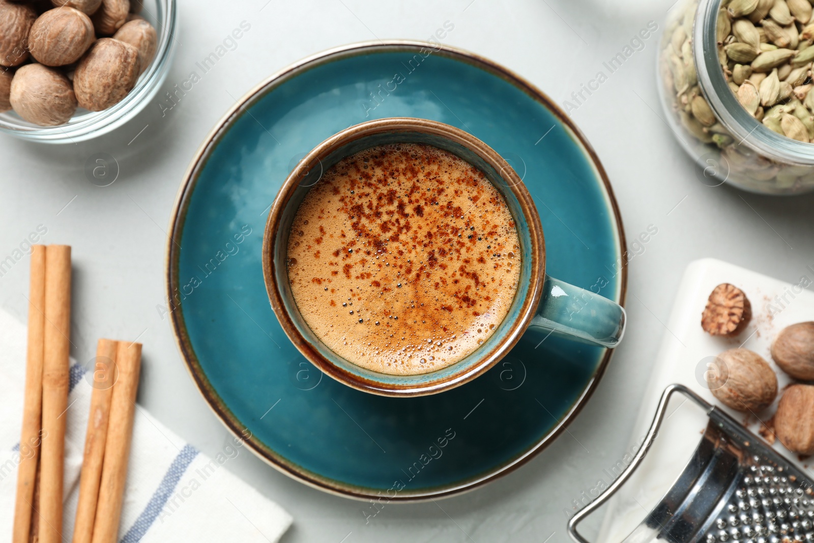 Photo of Coffee with nutmegs and spices on white table, flat lay