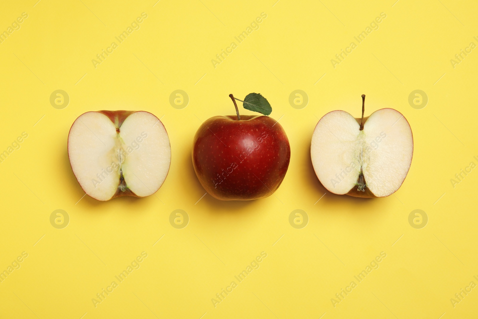 Photo of Flat lay composition with ripe juicy red apples on yellow background