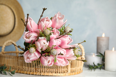 Photo of Beautiful bouquet with spring pink tulips on table