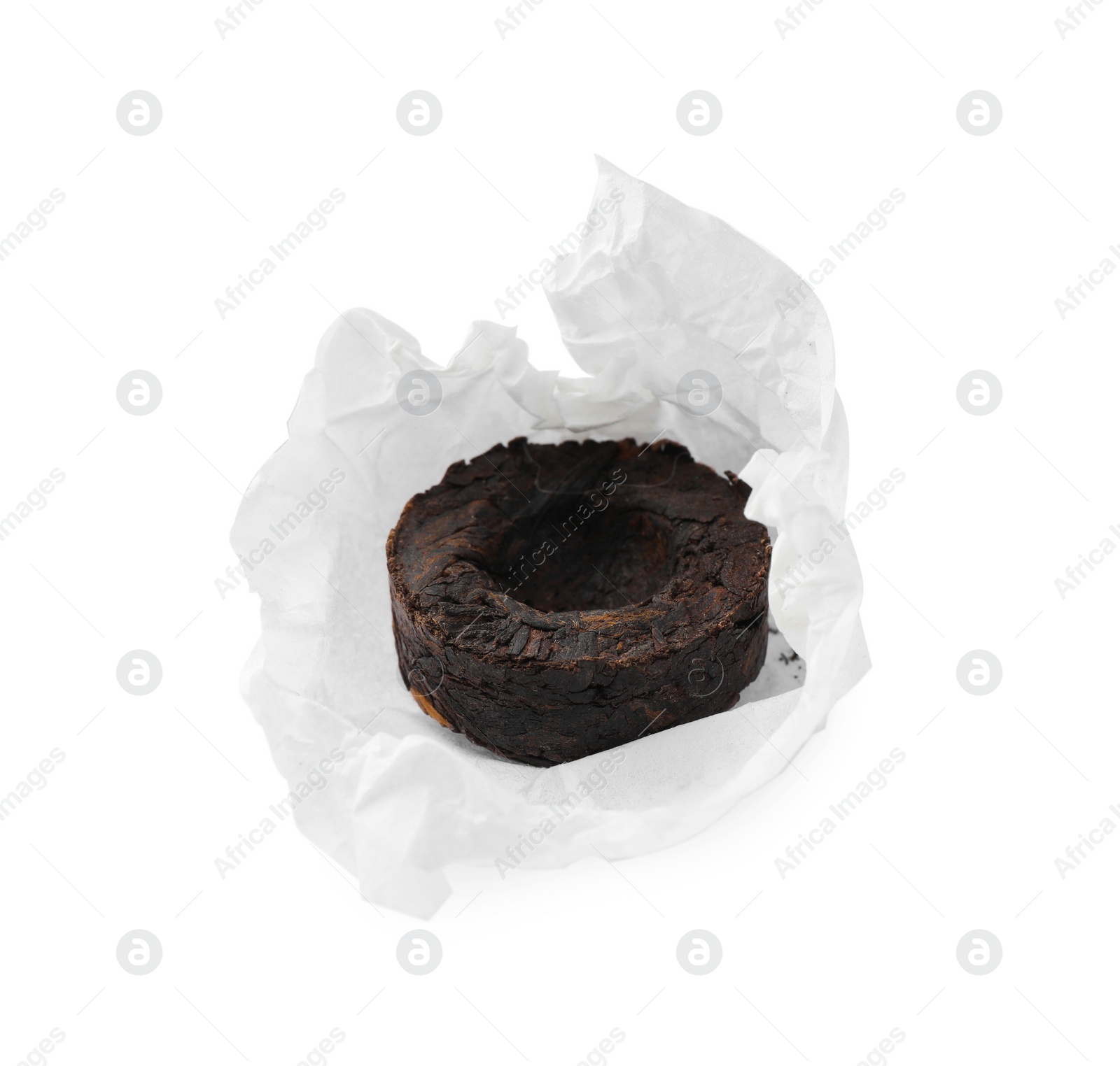Photo of Cake shaped traditional Chinese pu-erh tea with paper wrap isolated on white